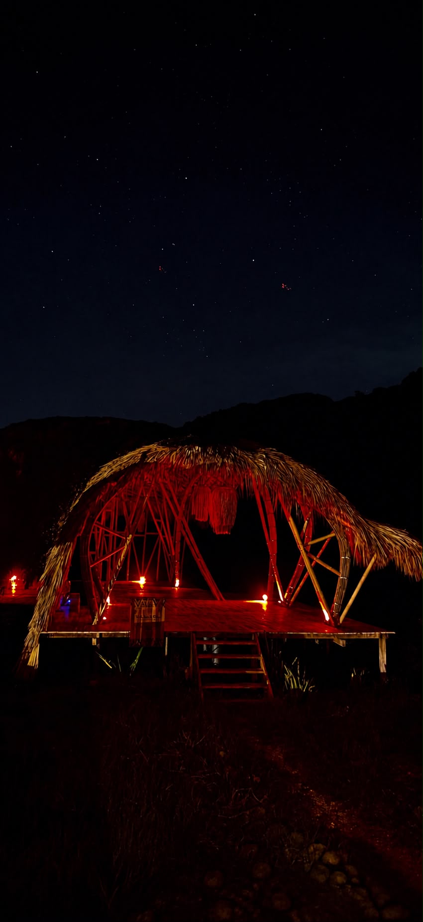 Open-air bamboo pavilion glowing beneath the stars in Mizata