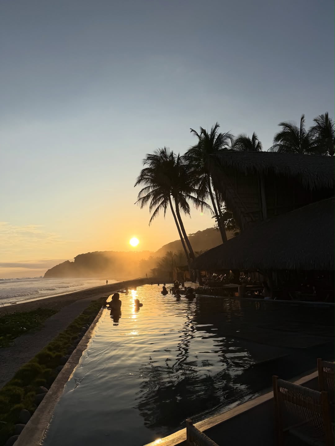 Sunset over the Pacific beside the resort pool in Mizata