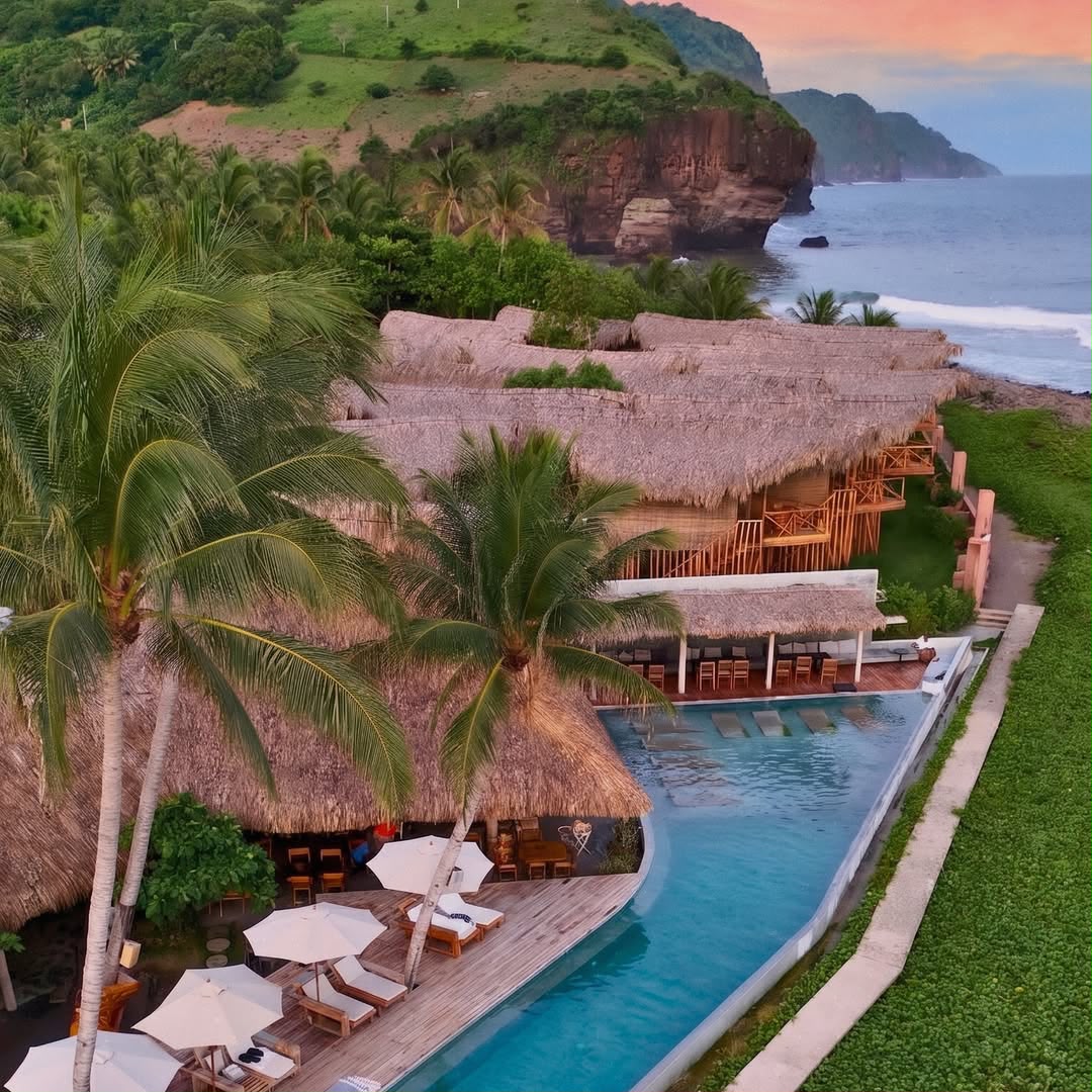 Oceanfront resort and palm trees beside the Pacific in Mizata, El Salvador
